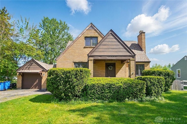 4207 Morningside Blvd, Dayton, OH 45432 - view of front facade featuring a front lawn, brick siding, a chimney, and a garage
