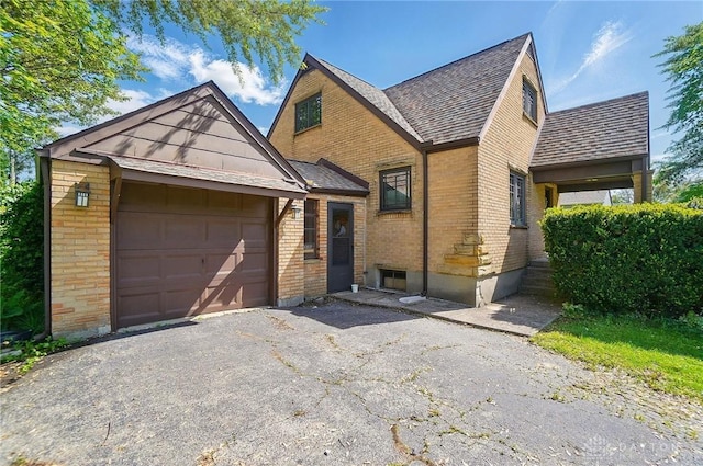 4207 Morningside Blvd, Dayton, OH 45432 - english style home with brick siding, asphalt driveway, and a garage