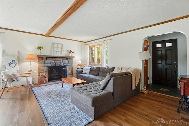 4207 Morningside Blvd, Dayton, OH 45432 - living room with arched walkways, wood finished floors, ornamental molding, a textured ceiling, and a fireplace