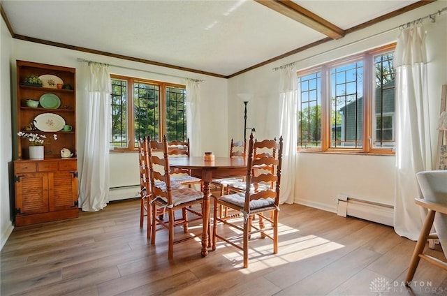 4207 Morningside Blvd, Dayton, OH 45432 - dining space featuring a baseboard heating unit, ornamental molding, plenty of natural light, light wood-type flooring, and baseboard heating