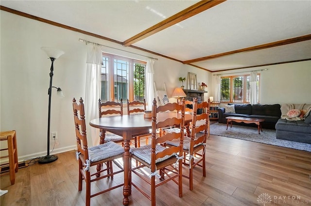 4207 Morningside Blvd, Dayton, OH 45432 - dining area featuring crown molding, light wood-style floors, beam ceiling, and baseboards