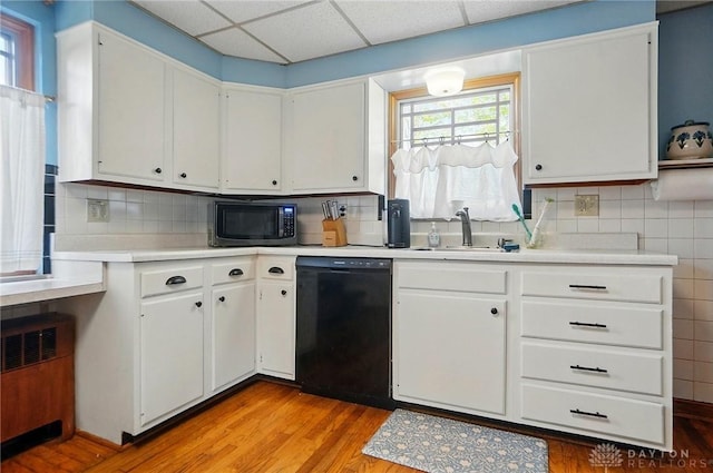 4207 Morningside Blvd, Dayton, OH 45432 - kitchen featuring dishwasher, a sink, light countertops, light wood finished floors, and white cabinets