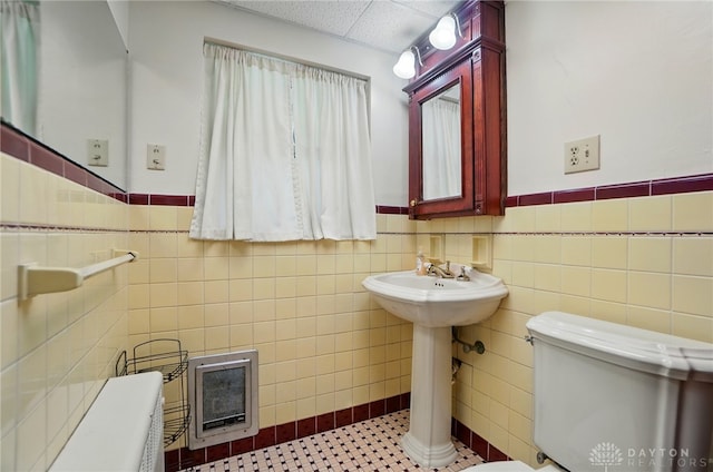 4207 Morningside Blvd, Dayton, OH 45432 - bathroom with tile walls, a wainscoted wall, toilet, and a sink