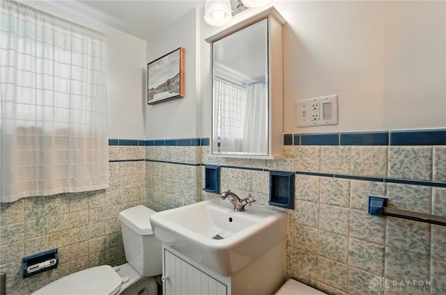 4207 Morningside Blvd, Dayton, OH 45432 - full bathroom featuring tile walls, toilet, a wainscoted wall, and vanity