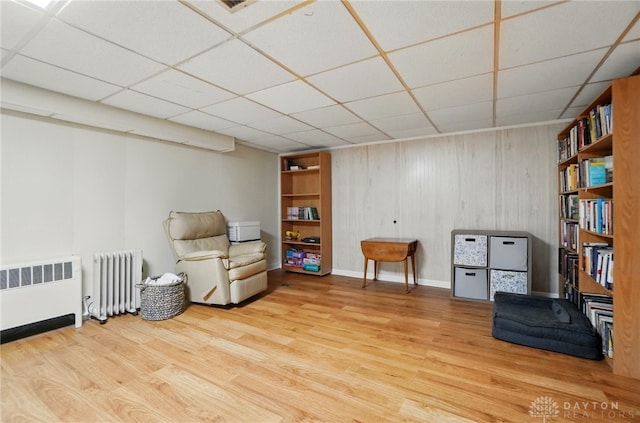 4207 Morningside Blvd, Dayton, OH 45432 - living area featuring radiator, wood finished floors, a paneled ceiling, and baseboards