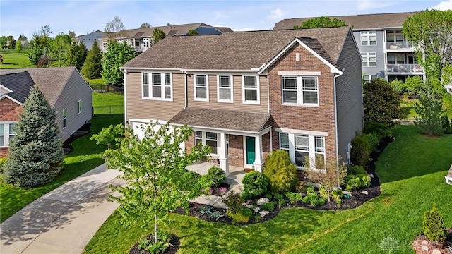 40 Shady Pines Ave, Springboro, OH 45066 - view of front of property featuring driveway, brick siding, a shingled roof, and a residential view