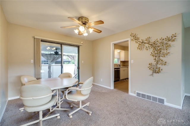 4231 Maricarr Dr, Dayton, OH 45429 - dining room with light carpet, a ceiling fan, and baseboards