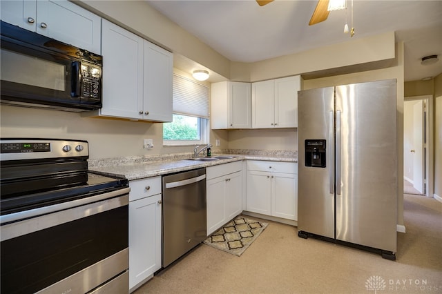 4231 Maricarr Dr, Dayton, OH 45429 - kitchen with stainless steel appliances, light countertops, white cabinets, and a sink