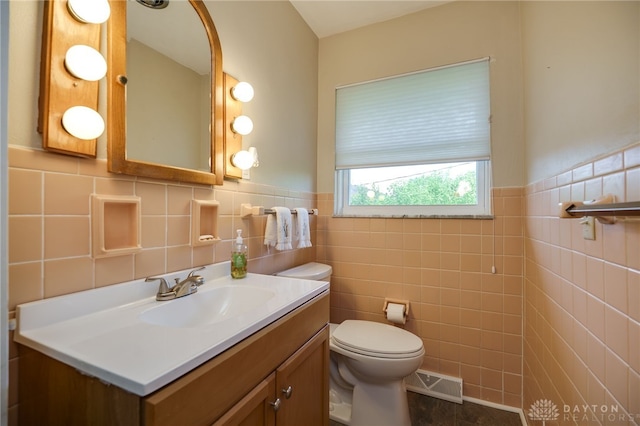 4231 Maricarr Dr, Dayton, OH 45429 - half bath with tile walls, toilet, vanity, a wainscoted wall, and tile patterned floors