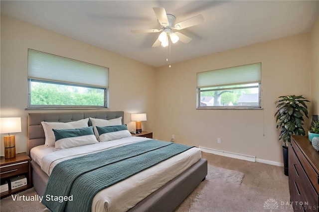 4231 Maricarr Dr, Dayton, OH 45429 - carpeted bedroom with a baseboard radiator, baseboards, and ceiling fan