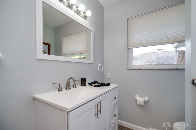 4231 Maricarr Dr, Dayton, OH 45429 - half bath with healthy amount of natural light, toilet, vanity, and baseboards