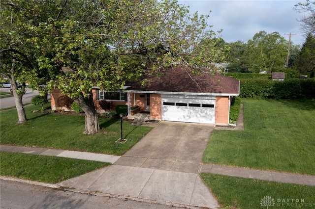 4231 Maricarr Dr, Dayton, OH 45429 - view of front of house featuring a front yard, brick siding, an attached garage, and concrete driveway