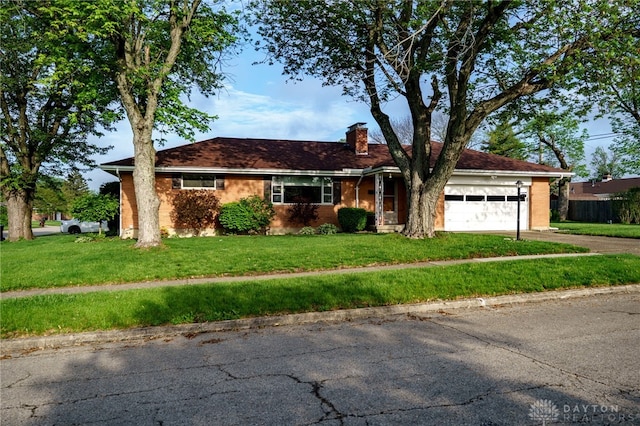 4231 Maricarr Dr, Dayton, OH 45429 - ranch-style house with a chimney, a garage, driveway, and a front yard