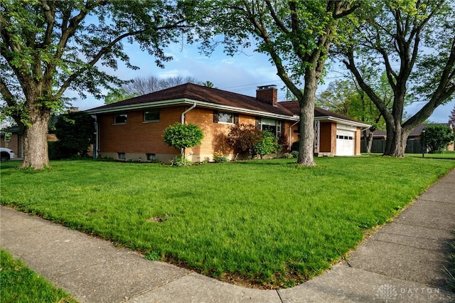 4231 Maricarr Dr, Dayton, OH 45429 - view of side of property featuring a chimney, a garage, a yard, and brick siding