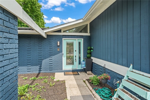 entrance to property with brick siding