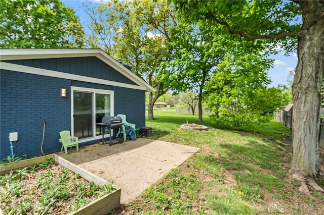 view of grassy yard with a patio