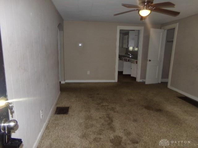 1719 Lamberton St, Middletown, OH 45044 - unfurnished living room featuring ceiling fan, carpet, and baseboards
