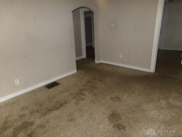 1719 Lamberton St, Middletown, OH 45044 - carpeted empty room featuring arched walkways and baseboards
