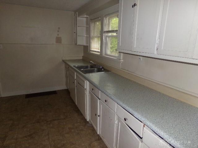 1719 Lamberton St, Middletown, OH 45044 - kitchen with a sink, white cabinets, and light countertops