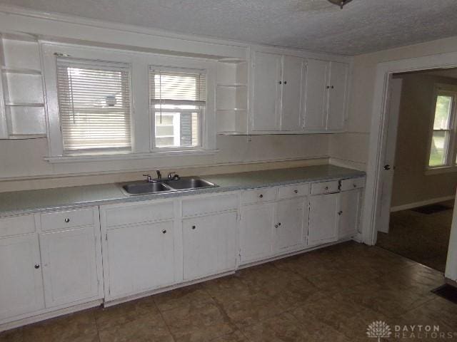 1719 Lamberton St, Middletown, OH 45044 - kitchen with a sink, white cabinetry, open shelves, light countertops, and a textured ceiling