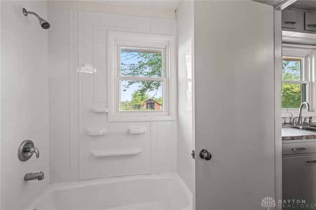 bathroom featuring shower / bath combination and a sink