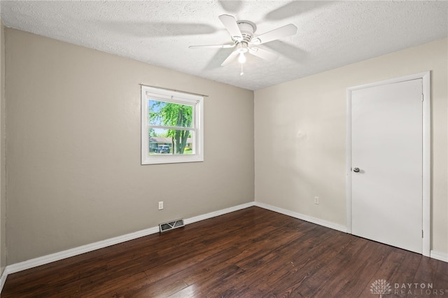 empty room featuring wood finished floors, ceiling fan, a textured ceiling, and baseboards