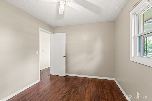 spare room featuring wood finished floors, baseboards, a textured ceiling, and a ceiling fan