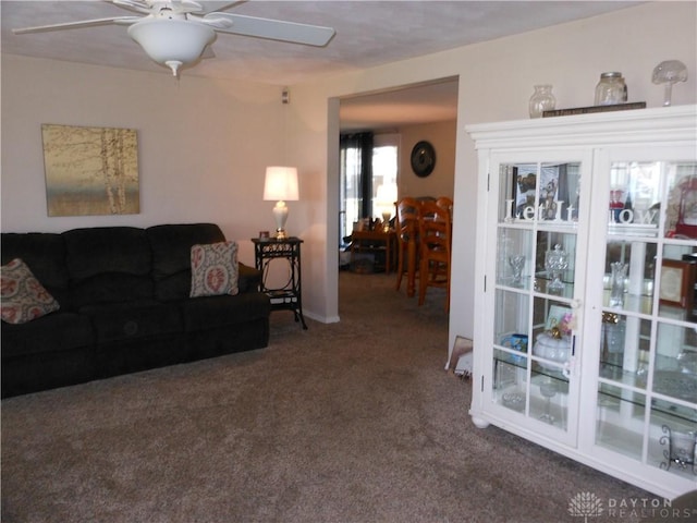 8189 Oakes Rd, Arcanum, OH 45304 - living area featuring ceiling fan and dark carpet