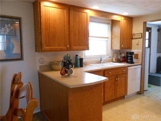 8189 Oakes Rd, Arcanum, OH 45304 - kitchen featuring dishwasher, a sink, light floors, light countertops, and a peninsula