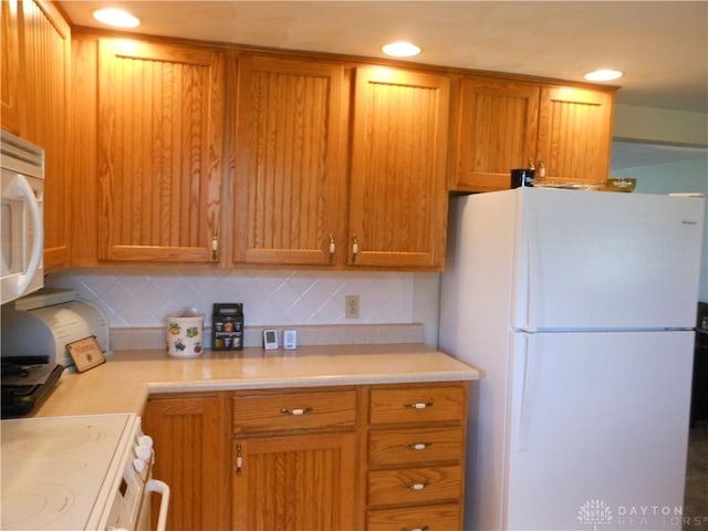 8189 Oakes Rd, Arcanum, OH 45304 - kitchen featuring white appliances, light countertops, backsplash, and recessed lighting