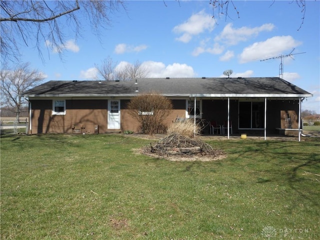 8189 Oakes Rd, Arcanum, OH 45304 - rear view of property featuring a lawn and a sunroom