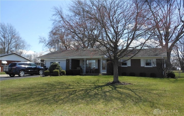8189 Oakes Rd, Arcanum, OH 45304 - single story home with a front lawn, covered porch, and a garage
