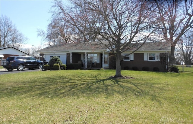8189 Oakes Rd, Arcanum, OH 45304 - ranch-style house featuring an attached garage and a front lawn