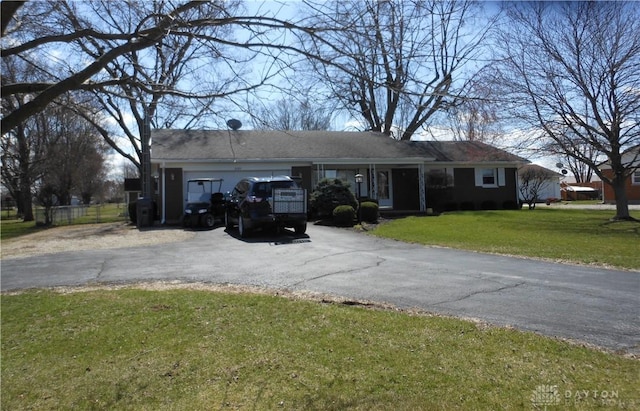 8189 Oakes Rd, Arcanum, OH 45304 - ranch-style home featuring driveway, an attached garage, and a front lawn
