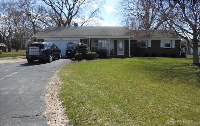 8189 Oakes Rd, Arcanum, OH 45304 - ranch-style house featuring driveway, a front yard, and a porch