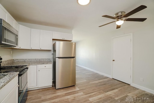 9738 Gibralter Dr, Colerain Township, OH 45251 - kitchen with stainless steel appliances, ceiling fan, white cabinetry, light wood-style flooring, and baseboards
