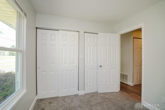 9738 Gibralter Dr, Colerain Township, OH 45251 - unfurnished bedroom featuring carpet, two closets, and baseboards