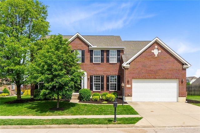 9378 Oak Brook Dr, Clearcreek Twp, OH 45458 - colonial home featuring concrete driveway, brick siding, a garage, and a shingled roof