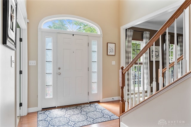 9378 Oak Brook Dr, Clearcreek Twp, OH 45458 - foyer entrance with light wood finished floors, plenty of natural light, and stairway