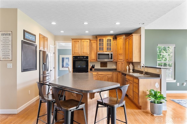 9378 Oak Brook Dr, Clearcreek Twp, OH 45458 - kitchen with black appliances, a sink, dark countertops, baseboards, and recessed lighting