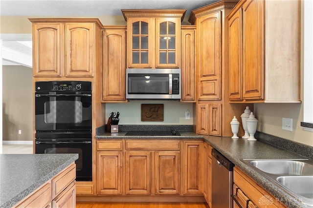 9378 Oak Brook Dr, Clearcreek Twp, OH 45458 - kitchen featuring black appliances, dark countertops, glass insert cabinets, and brown cabinets