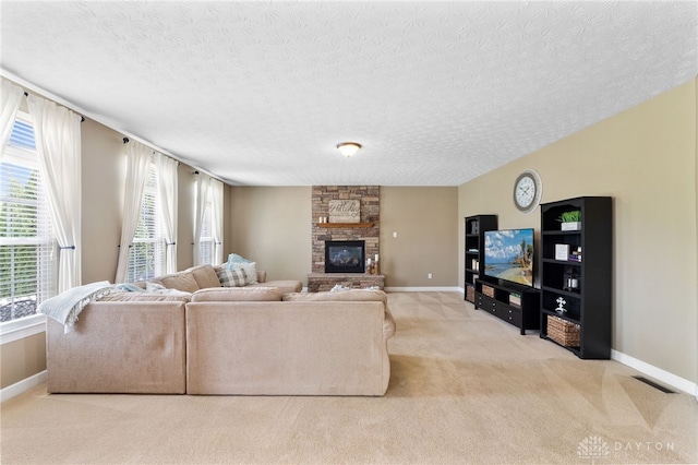 9378 Oak Brook Dr, Clearcreek Twp, OH 45458 - carpeted living area with a textured ceiling, baseboards, and a stone fireplace
