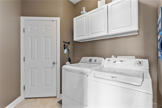 9378 Oak Brook Dr, Clearcreek Twp, OH 45458 - washroom with cabinet space, washer and clothes dryer, and baseboards