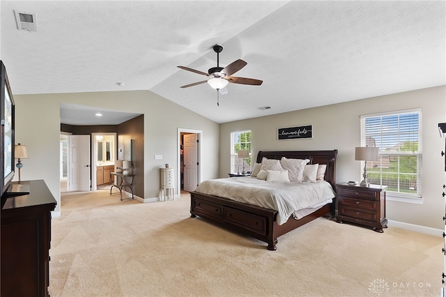 9378 Oak Brook Dr, Clearcreek Twp, OH 45458 - bedroom with baseboards, light carpet, vaulted ceiling, connected bathroom, and a textured ceiling