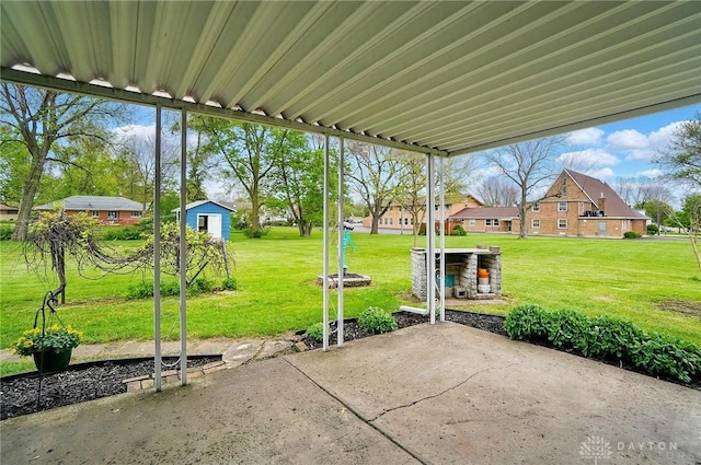 view of patio with an outbuilding