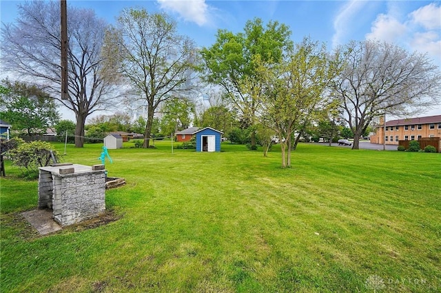 view of green lawn with a storage unit and an outdoor structure
