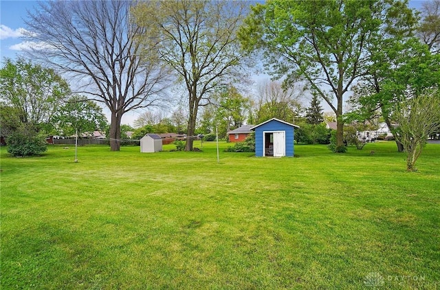 view of grassy yard with a shed and an outdoor structure