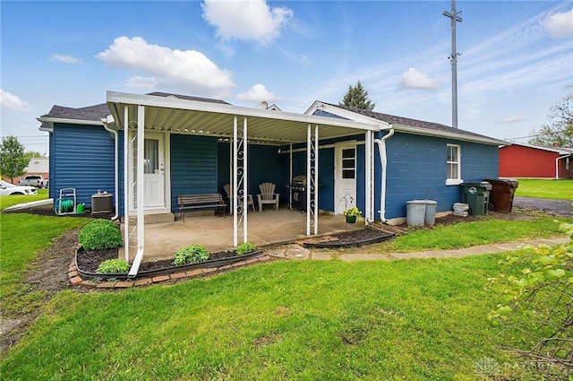 rear view of property with a yard and central AC unit