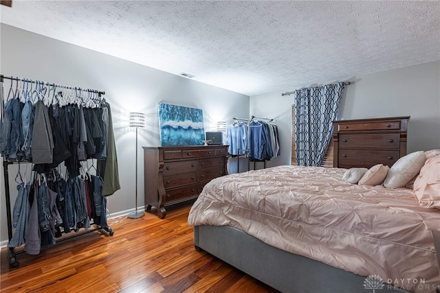 2540 Greenside Dr, Beavercreek, OH 45431 - bedroom with wood finished floors, a textured ceiling, and baseboards