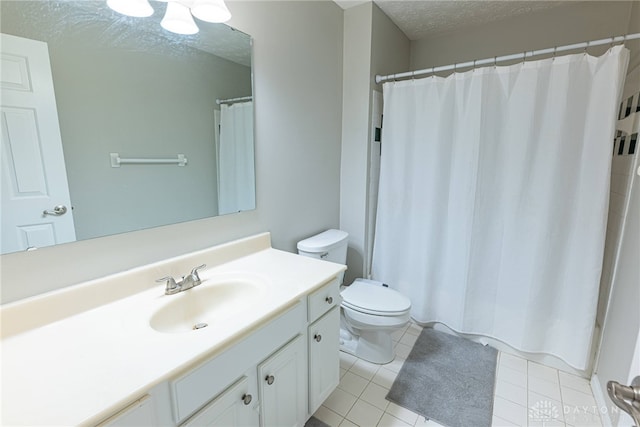 2540 Greenside Dr, Beavercreek, OH 45431 - full bath featuring a textured ceiling, toilet, tile patterned flooring, and vanity